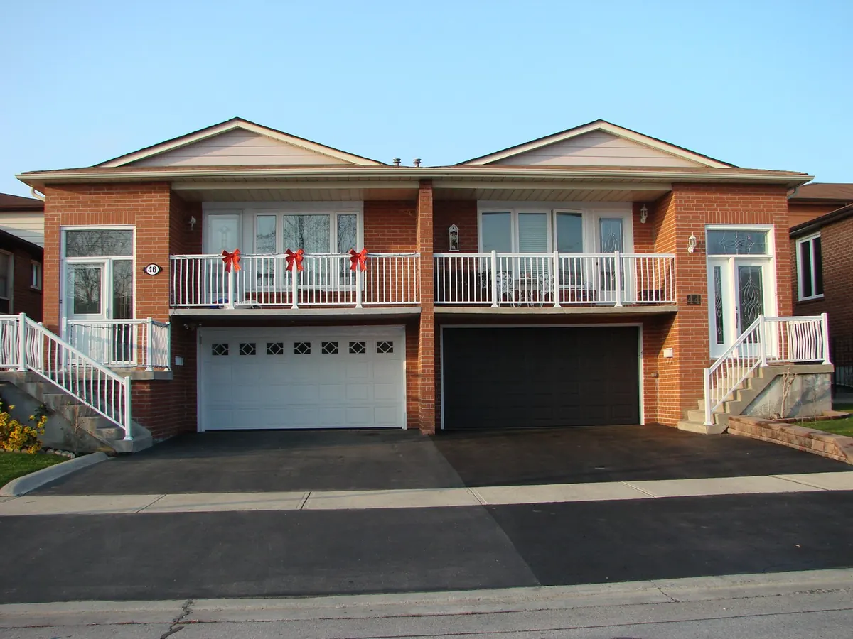 White aluminum balcony railings on adjacent twin homes