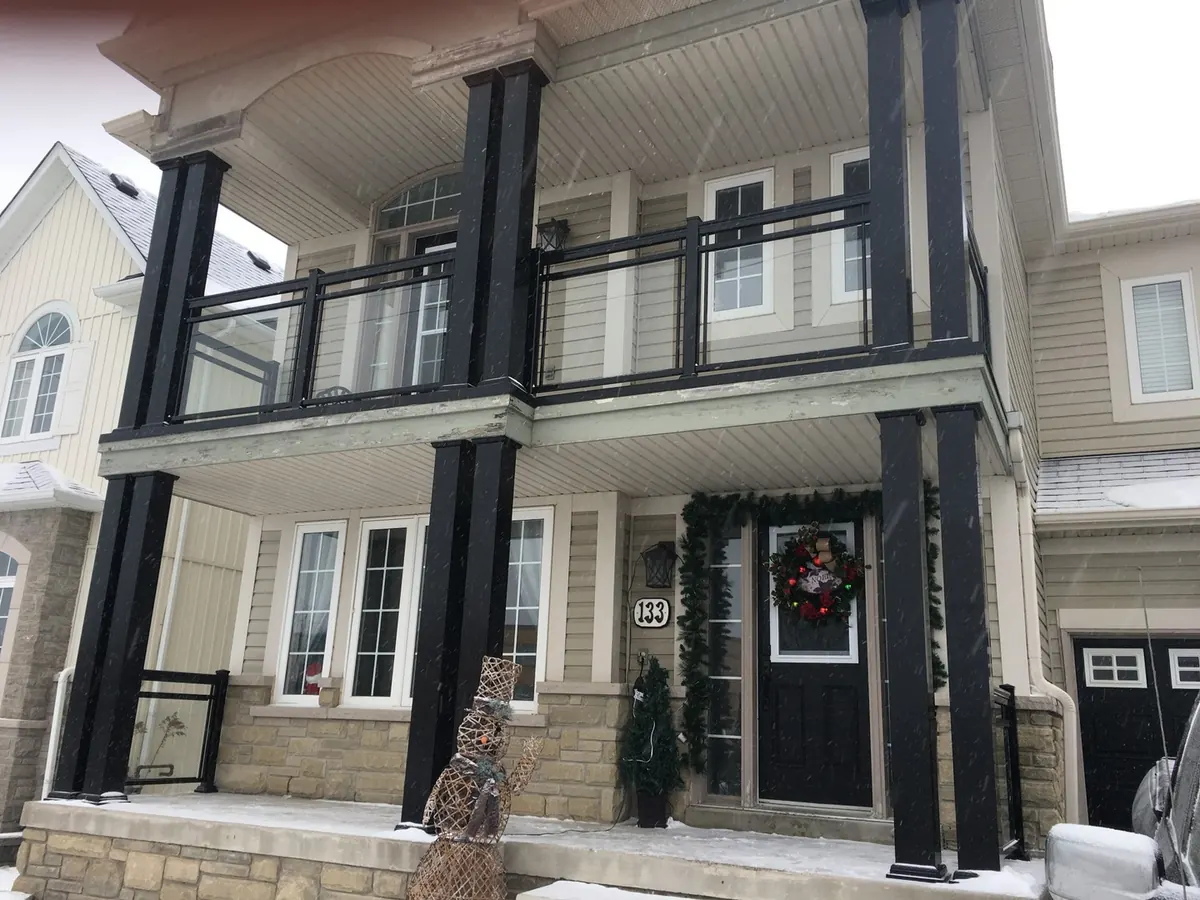 Charcoal aluminum-wrapped columns on twin entry porch with brick facade